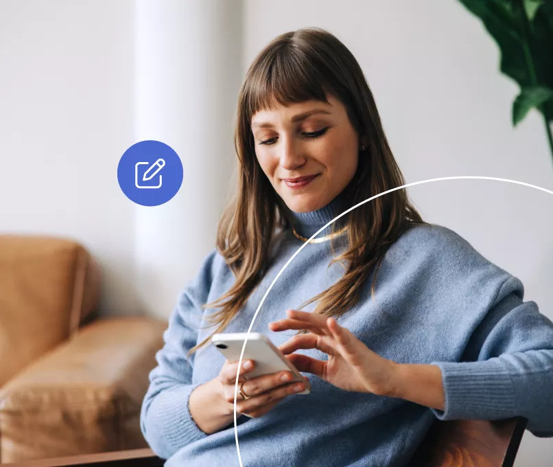 woman smiling and using her phone