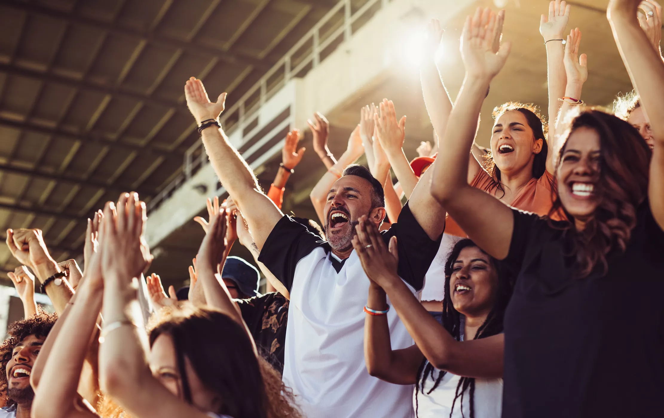 Crowd of sports fans cheering during soccer game