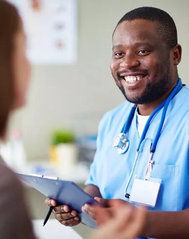 A nurse works with a patient in a clinic.