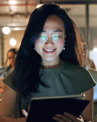 A woman uses a tablet in the office.