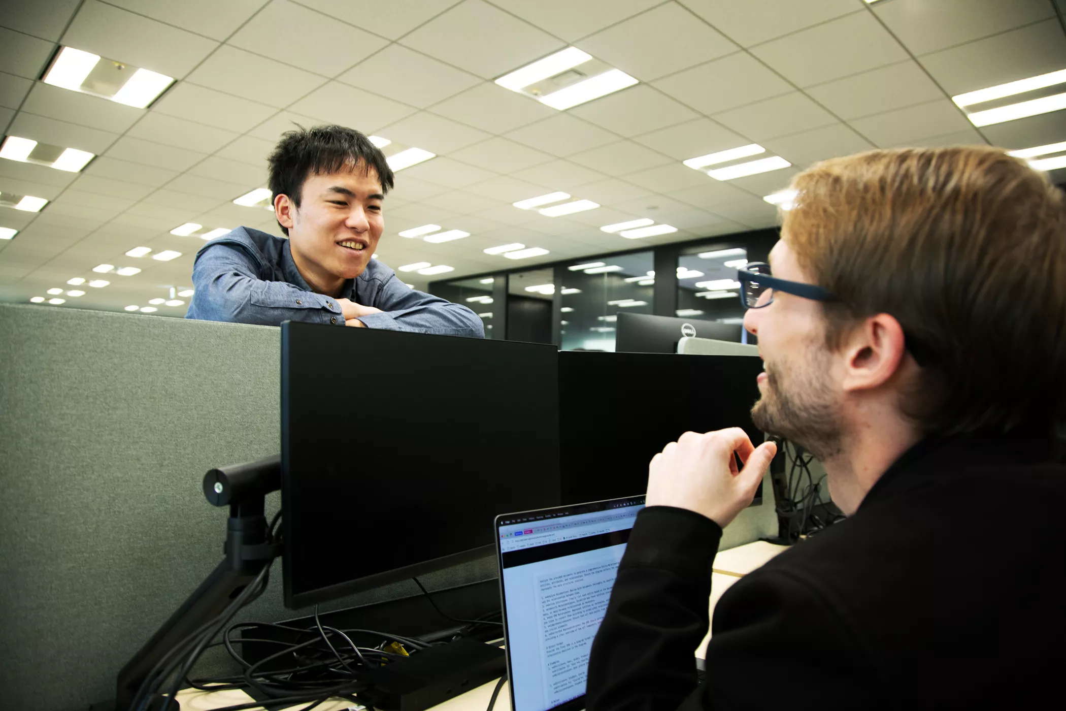 Kojiro Iizuka talking to a coworker