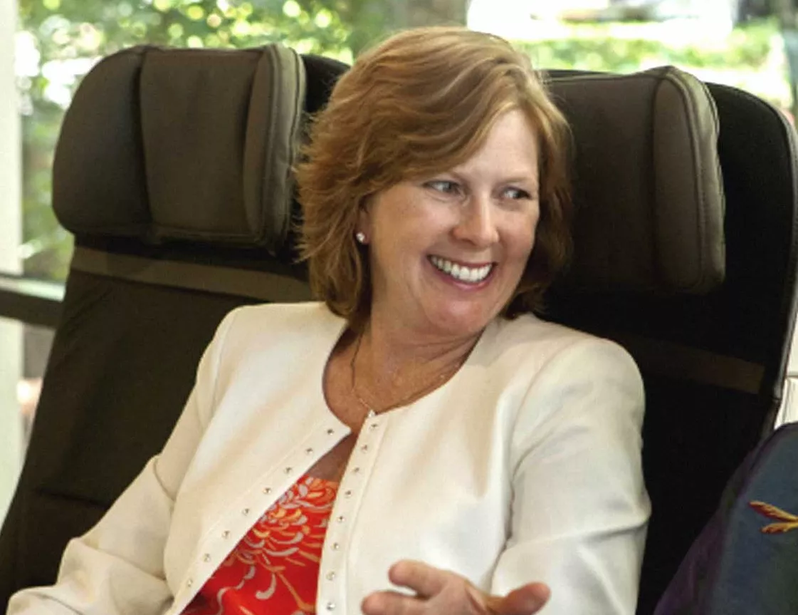 Woman smiling sitting at person next to her