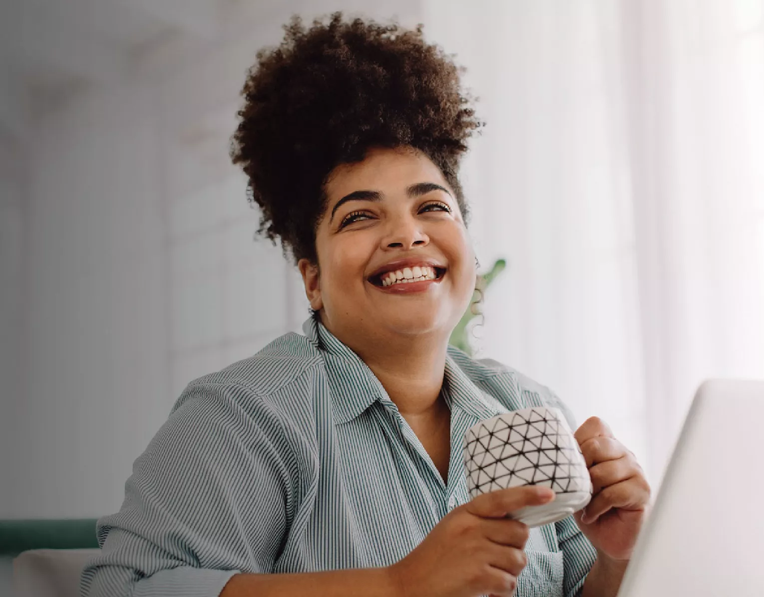 Woman smiling while drinking her coffee
