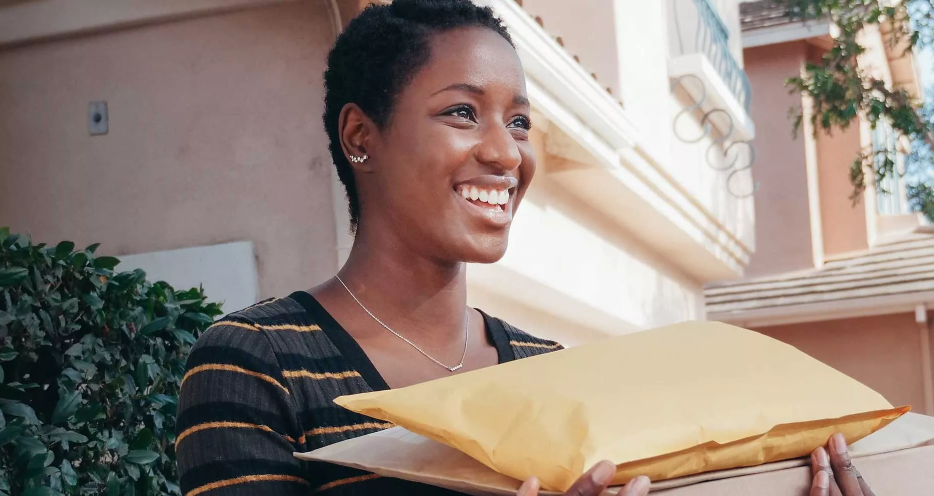 Woman carrying packages and smiling