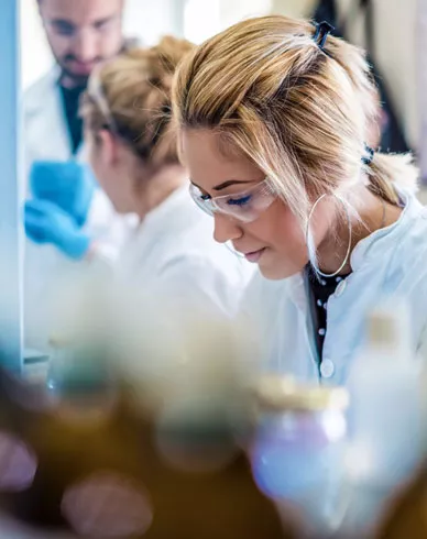 Researcher in lab with safety glasses on