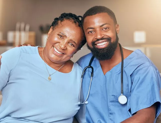 Woman patient with male nurse smiling