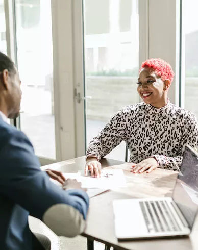 Three people meet to discuss banking matters.