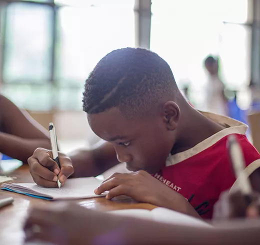 Child in a classroom working on an assignment.