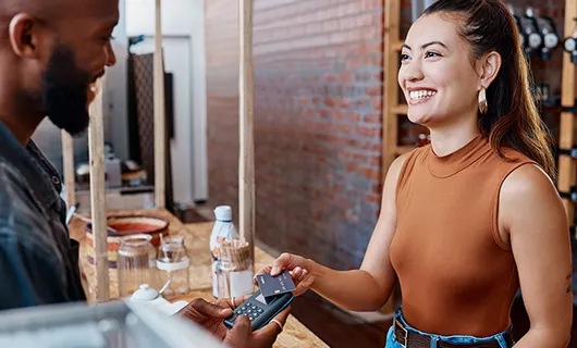 Woman Paying with Credit Card by Tapping