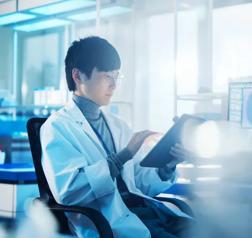 A man works with a tablet in a lab.