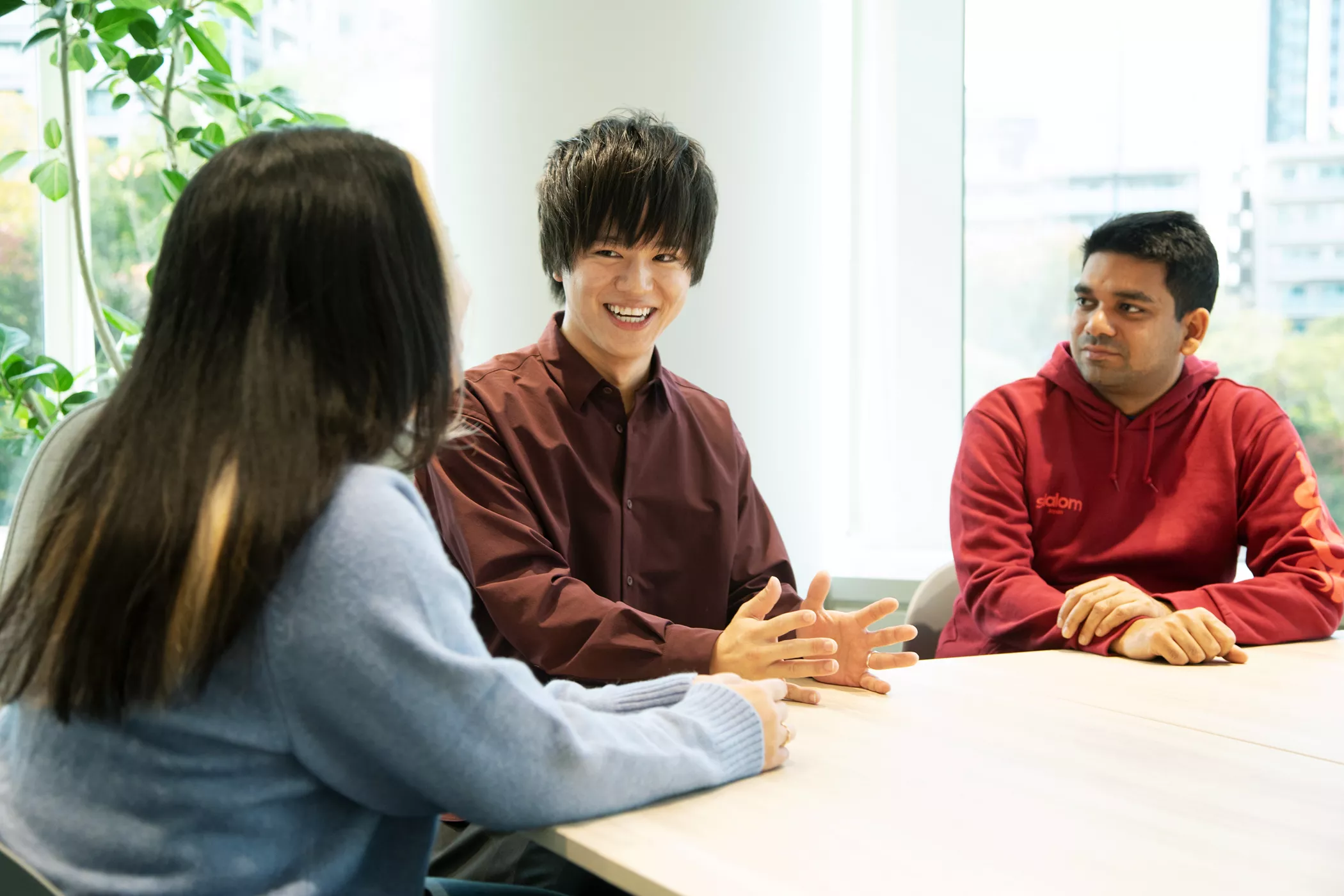 Takuma Doi talking to coworkers