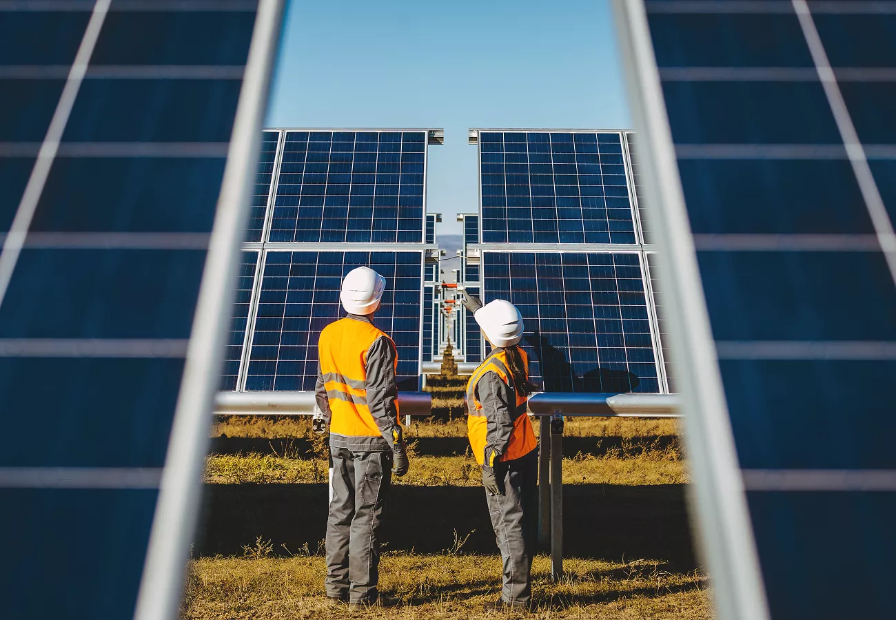 workers looking at solar panels