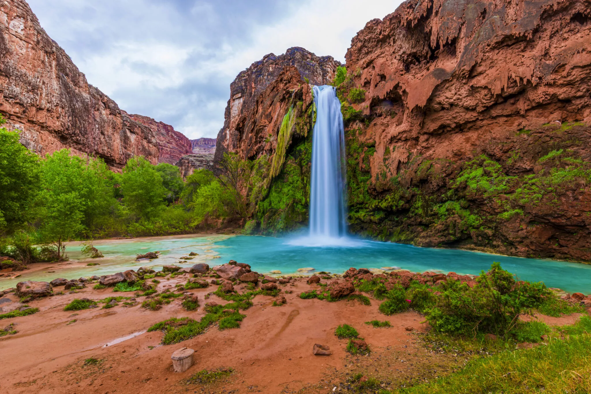 a waterfall coming from the wall of a canyon