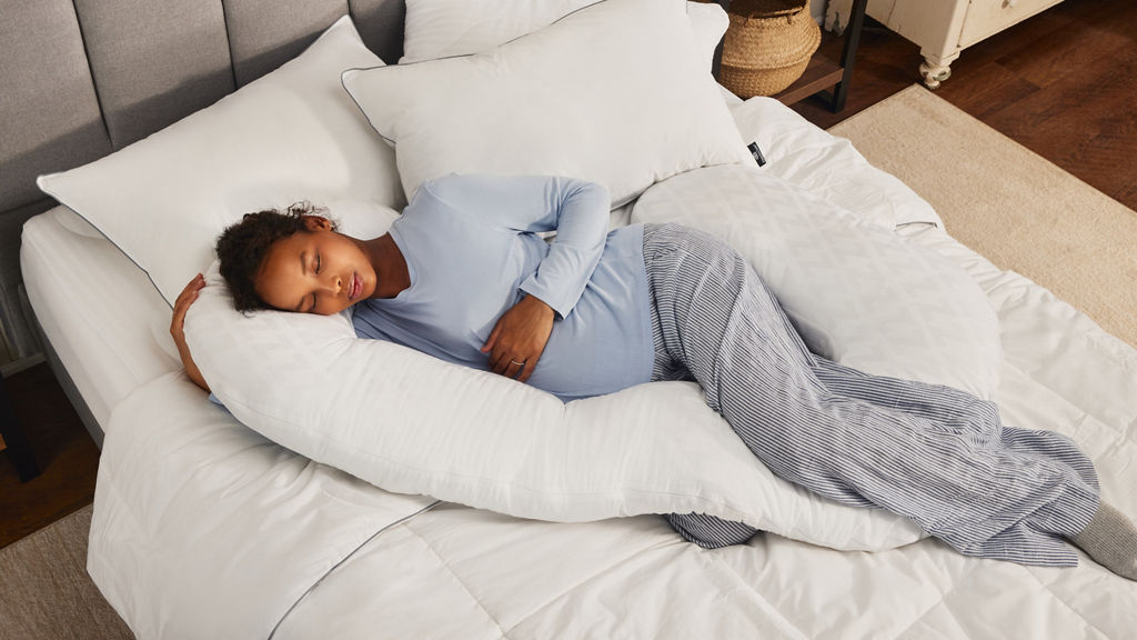 young woman sleeping with body pillow