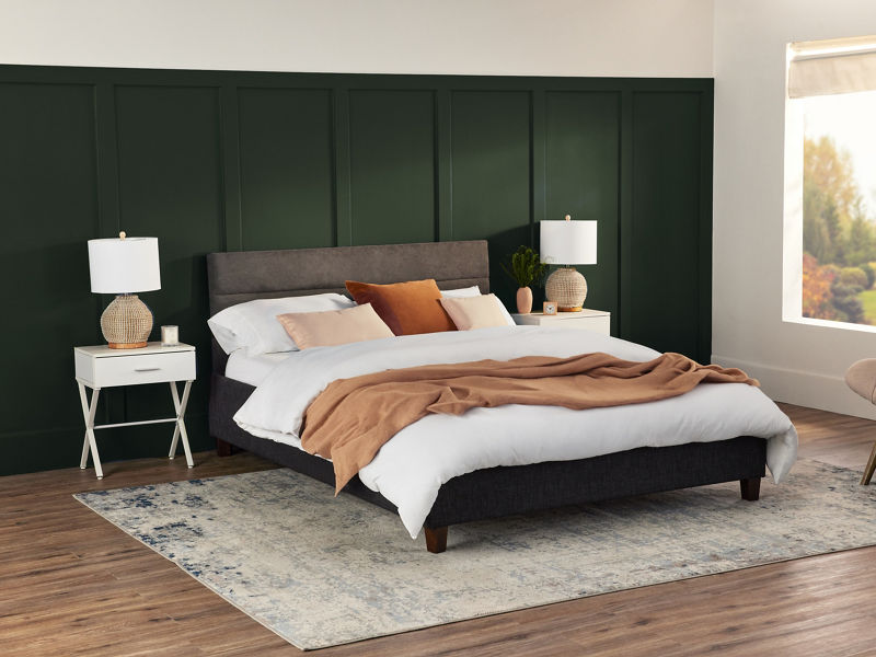 Medium-firm Serta Daystar mattress in a modern bedroom with blue pillows and black nightstands