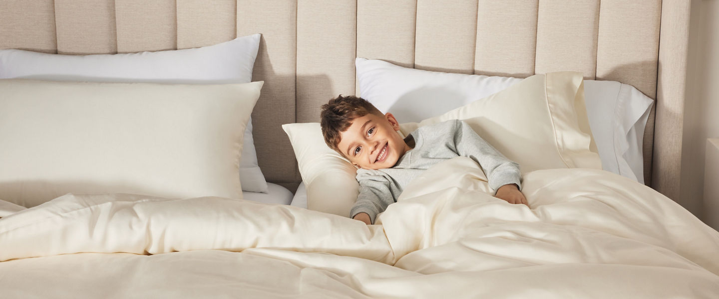 Young Boy on bed with headboard