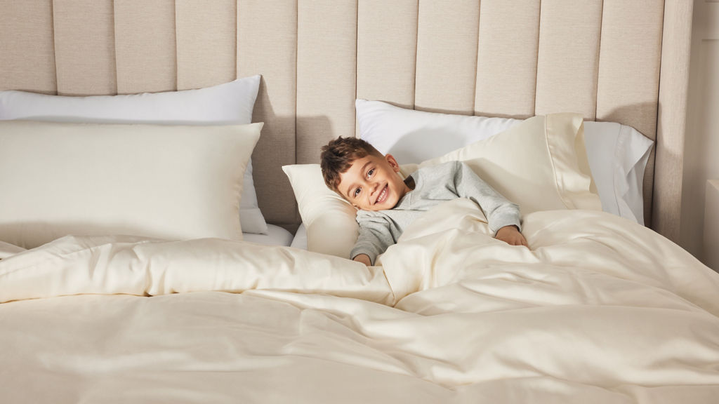 Young Boy on bed with headboard