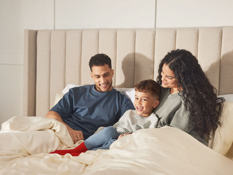 Couple with small child in bed
