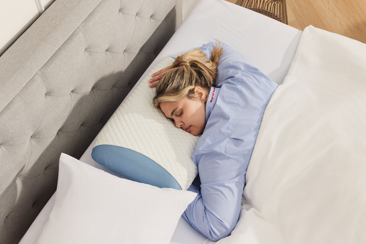 woman on stomach sleeper pillow