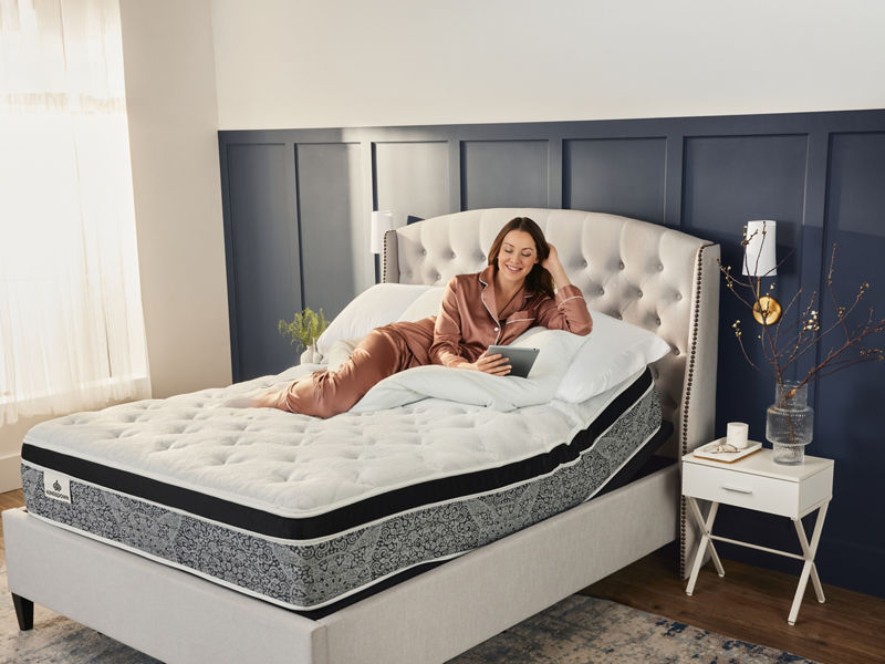 Mother and child playing on bed
