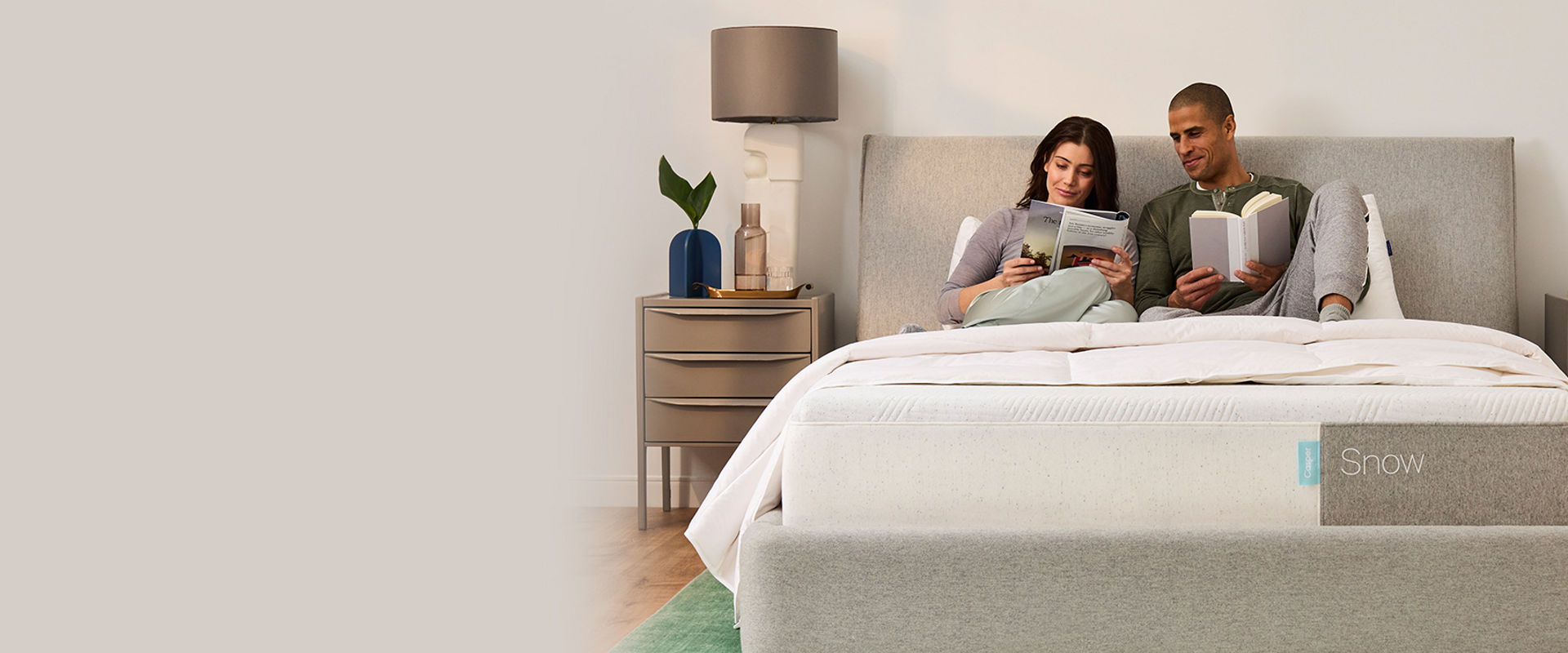 Couple reading on a Casper Snow Bed