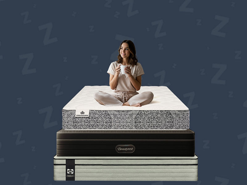 Medium-firm Serta Daystar mattress in a modern bedroom with blue pillows and black nightstands