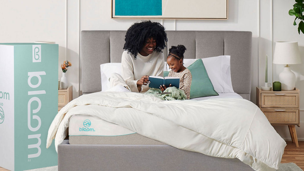 Mother Daughter sitting on Bloom Bed