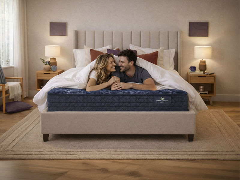 Medium-firm Serta Daystar mattress in a modern bedroom with blue pillows and black nightstands