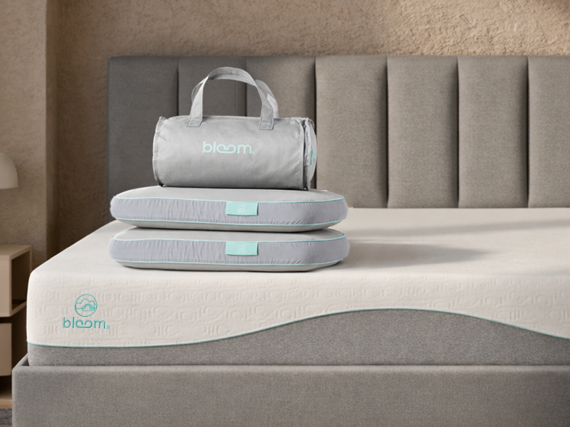 Medium-firm Serta Daystar mattress in a modern bedroom with blue pillows and black nightstands
