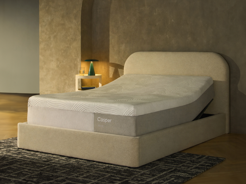 Medium-firm Serta Daystar mattress in a modern bedroom with blue pillows and black nightstands