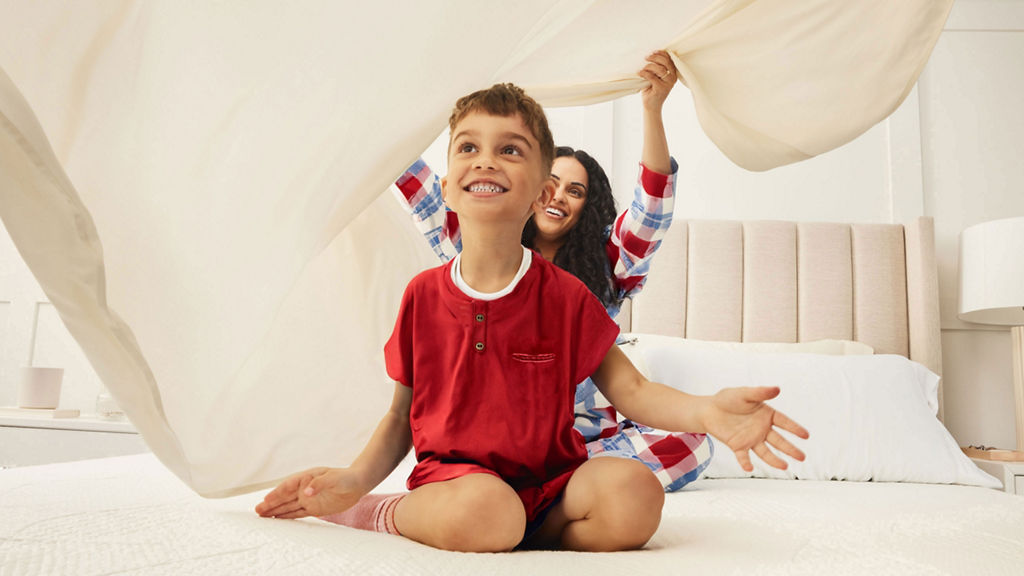 Mother and son playing under sheets