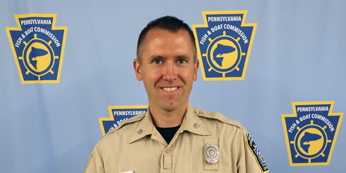 Waterways Conservation Officer Zachary M. Rudd, awarded NASBLA Boating Law Enforcement Officer of the Year pictured on a light blue background with PFBC logos on it.