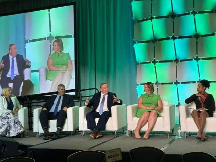 people sitting and talking on a stage