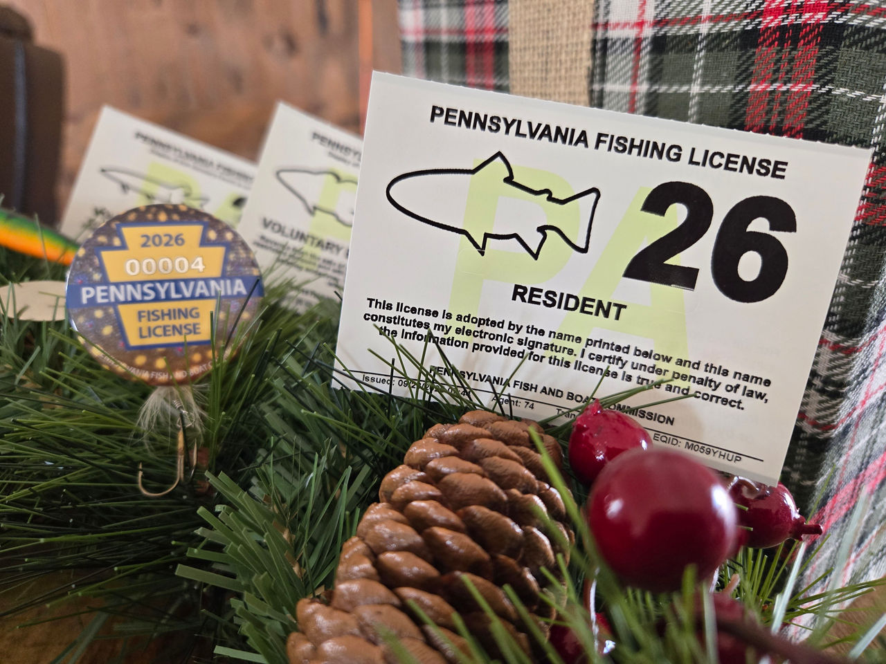 2026 pa fishing license and 2026 collective fishing license button on holiday backdrop