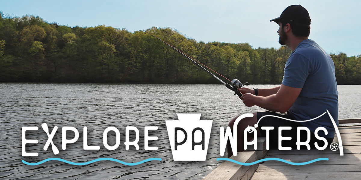 Man sitting on the edge of a dock on a lake fishing. The words "Explore PA Waters" are at the bottom.
