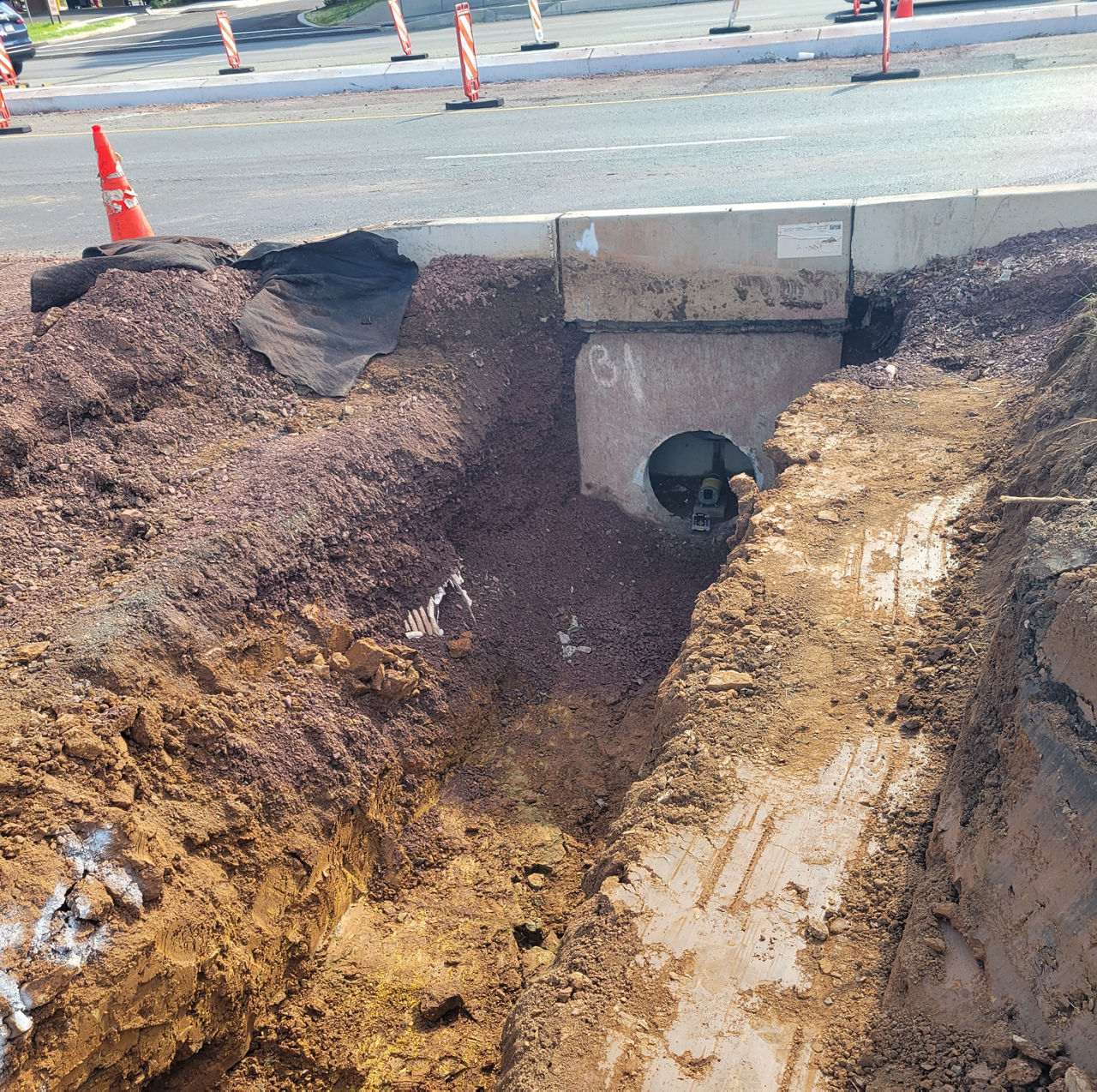 Cement drainage hole installed; dirt walls and bottom leading up to new structure