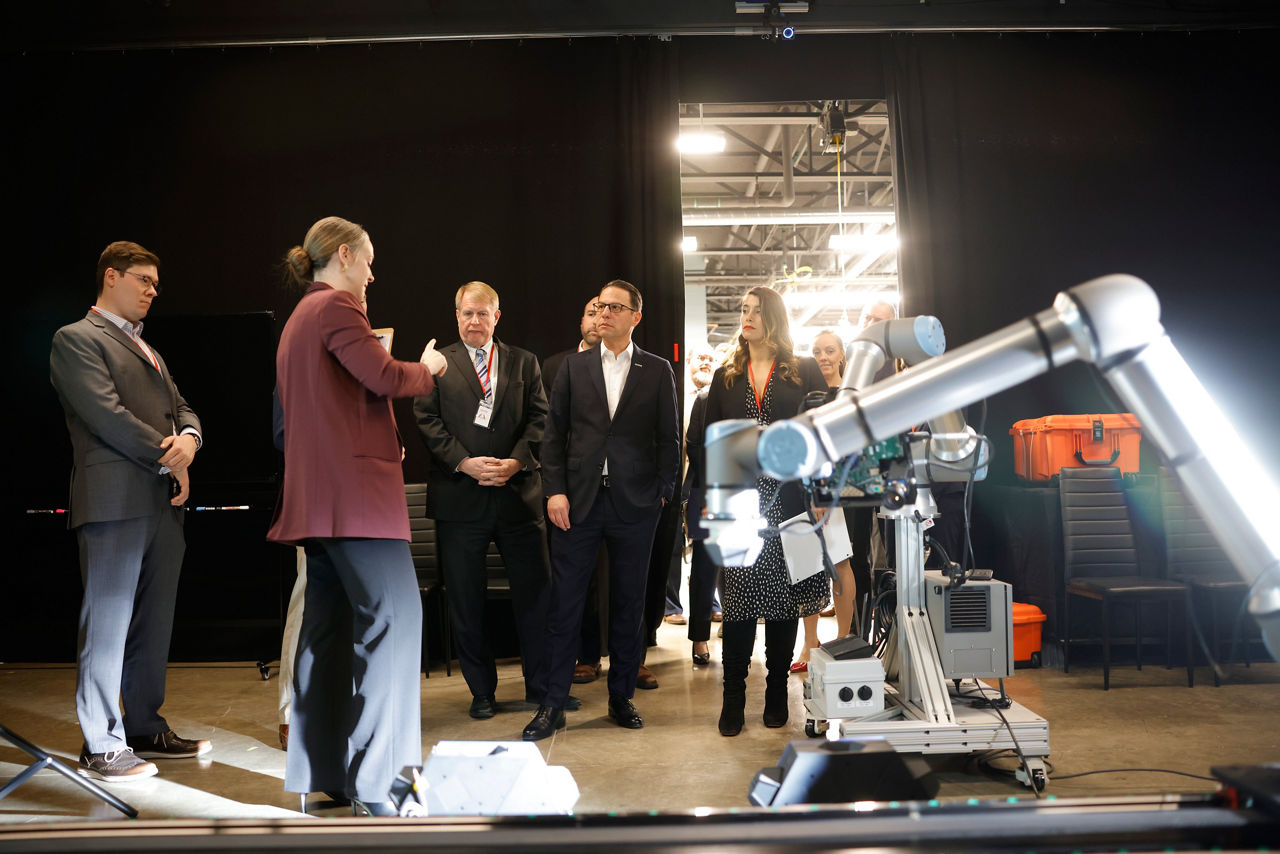 Astrobotic employees show off a robotic arm prototype in their facility to Gov. Josh Shapiro and cohorts.