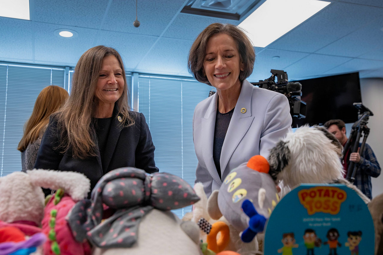 L and I Secretary Nancy A. Walker and DHS Secretary Valerie A. Arkoosh, look at table full of stuffed toys, during annual toy drive.