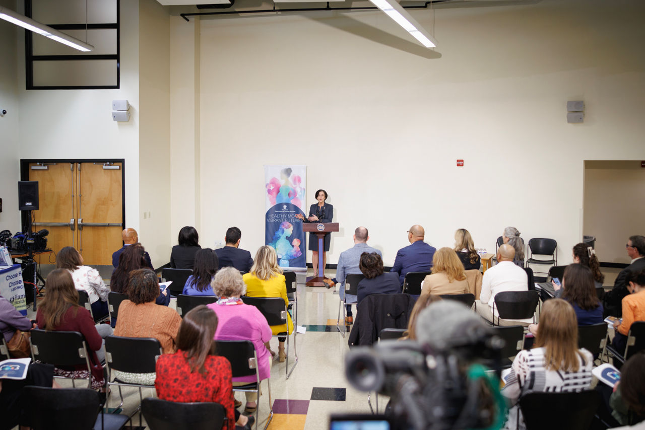 DHS Secretary Val Arkoosh announces the plan in a full room