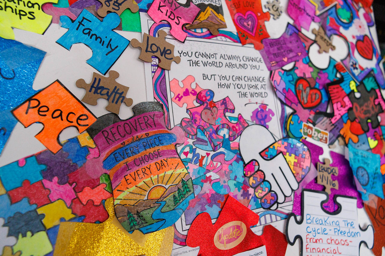 Resident artwork at RESET BC features colorful puzzle pieces arranged around the message, “Recovery is every piece I choose today,” using “piece” as a play on the word “peace.”