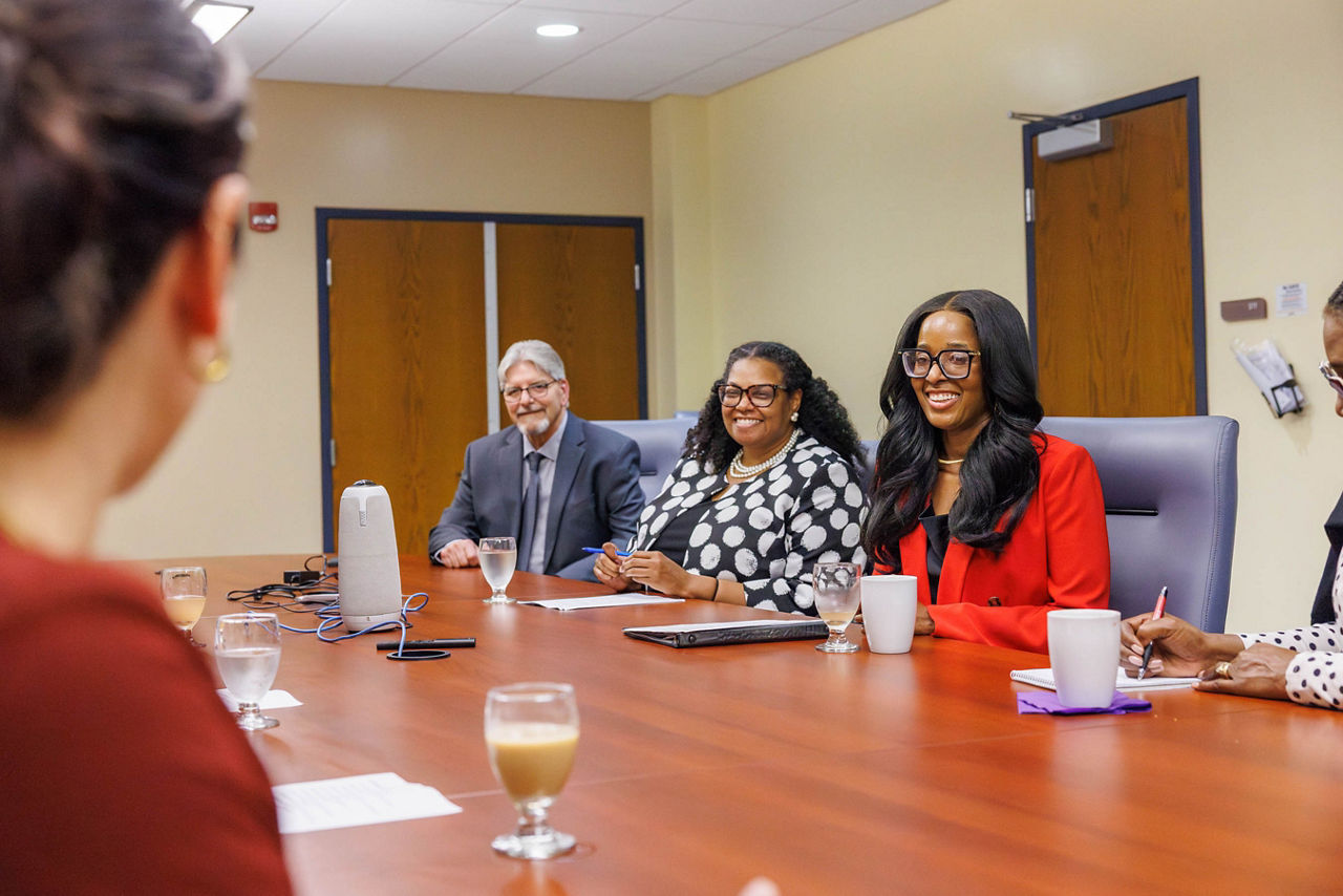 Pennsylvania Department of Drug and Alcohol Programs Secretary Dr. Latika Davis-Jones sits at a table with Dr. Fawn Robinson and other Carlow University leaders to discuss the university's Addiction Counseling Workforce Impact Project.