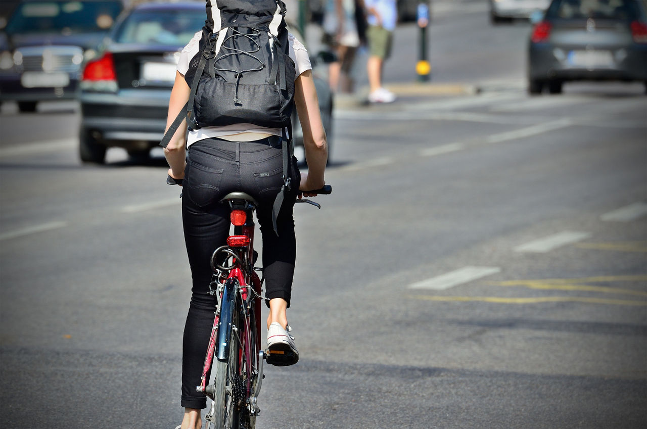 Person on bike in evening traffic