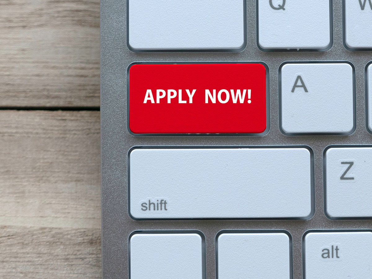 Image of a computer keyboard with a red button that says Apply Now.