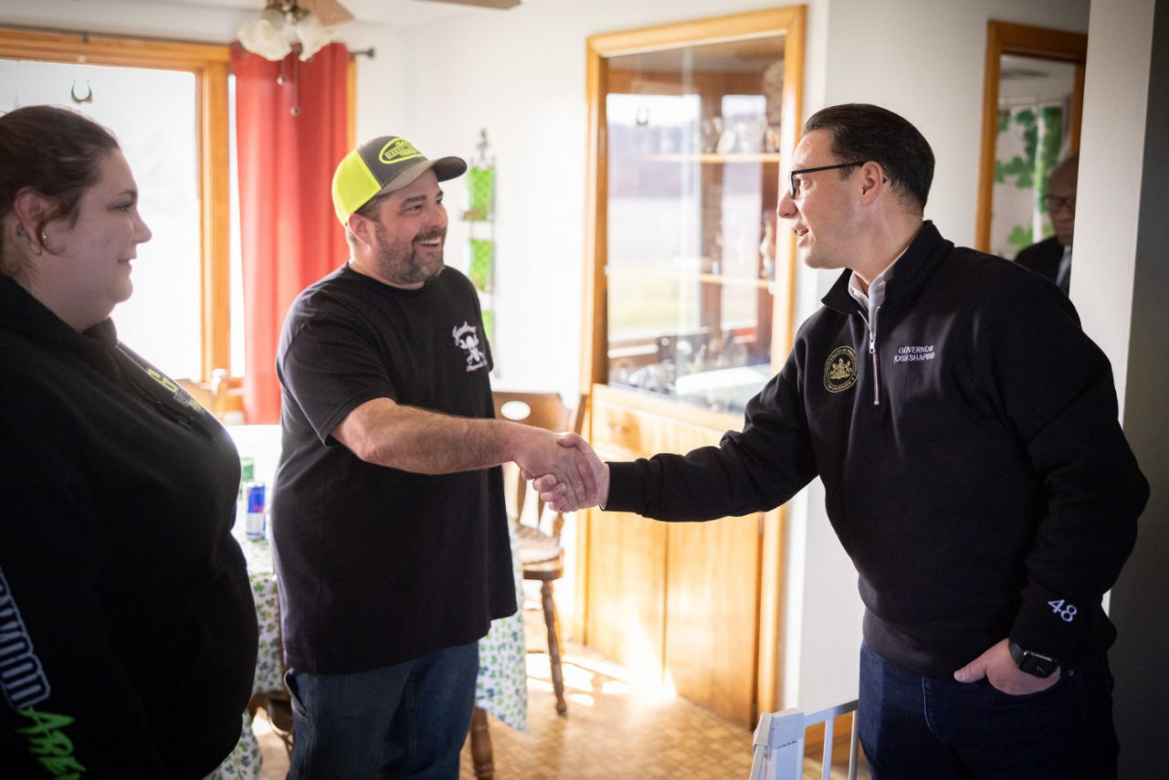 Governor Shapiro shaking hands with a man 