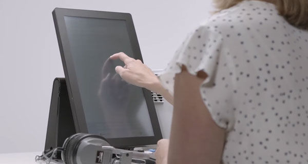 Person making selections on the ballot marking device touchscreen