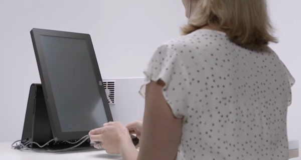 Person using tactile keys to make selections and reviewing ballot