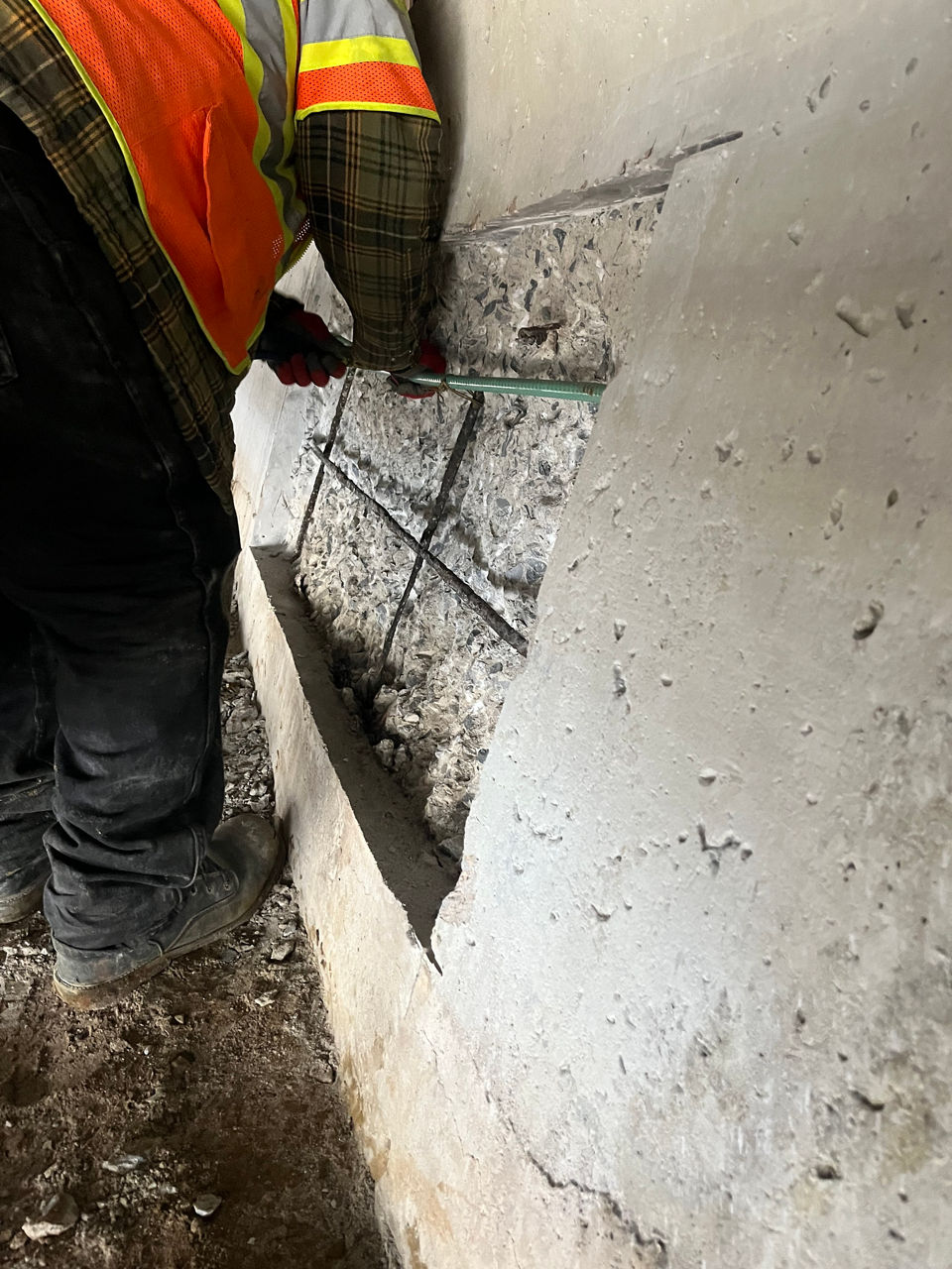 Person repairing concrete under the bridge