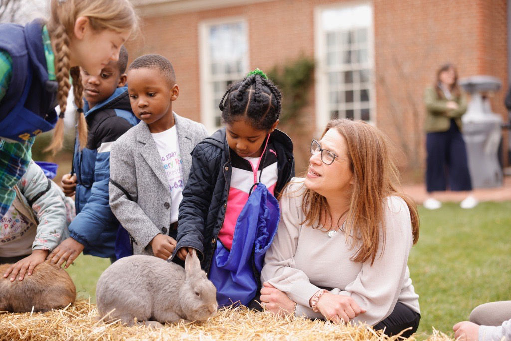 First Lady Lori Shapiro crouching next to a girl and a rabbit