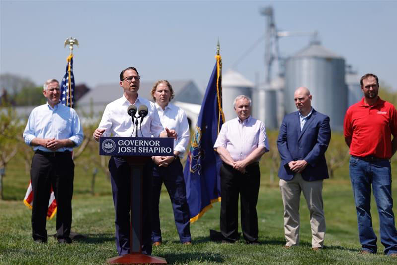 Governor Shapiro speaking at a podium standing at a farm