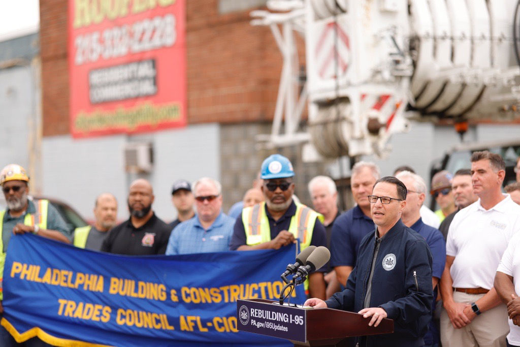 Governor Shapiro standing at a podium talking about rebuilding i-95. 